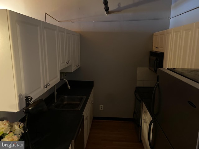 kitchen featuring dark hardwood / wood-style flooring, sink, dishwasher, white cabinetry, and fridge