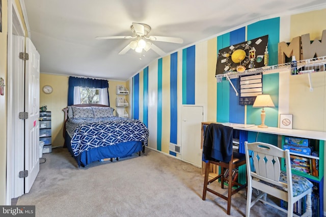 carpeted bedroom with ceiling fan and ornamental molding