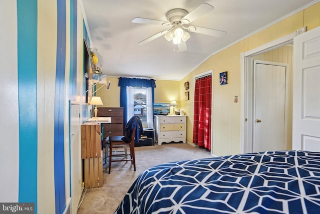 carpeted bedroom with crown molding, a closet, and ceiling fan