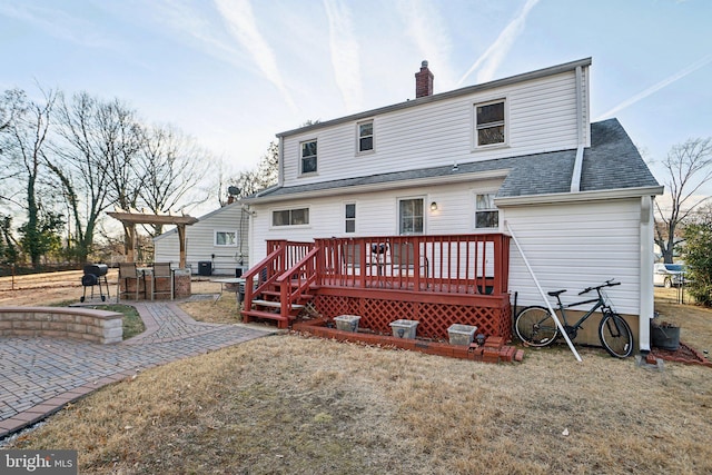 rear view of house with a patio area and a wooden deck