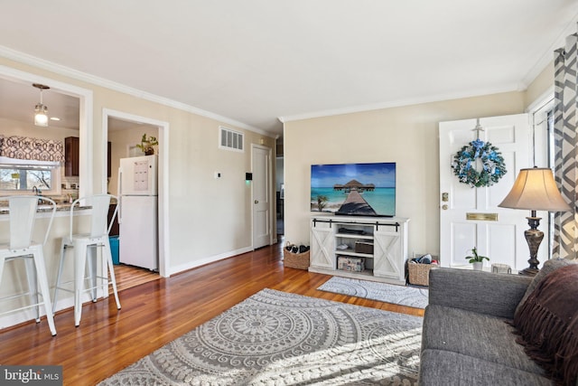 living room with crown molding and dark wood-type flooring