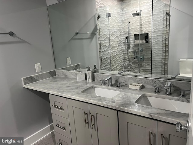 bathroom featuring vanity and a shower with door