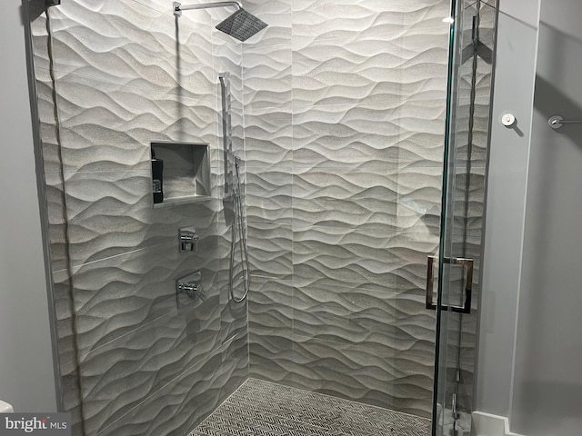 bathroom with a tile shower