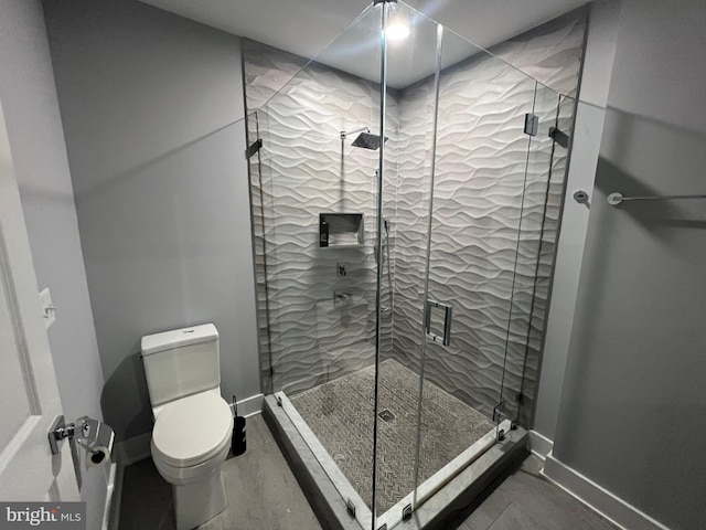 bathroom featuring toilet and walk in shower