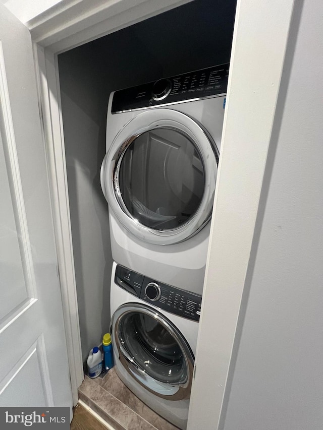 laundry area with stacked washing maching and dryer