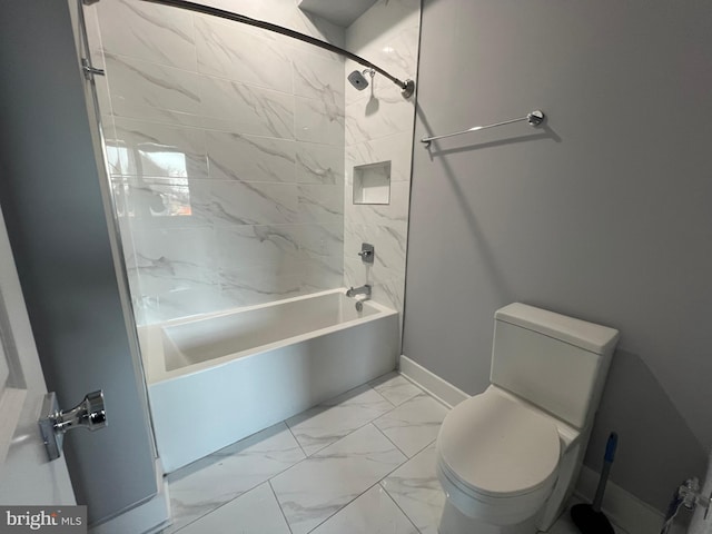 bathroom with tiled shower / bath combo and toilet