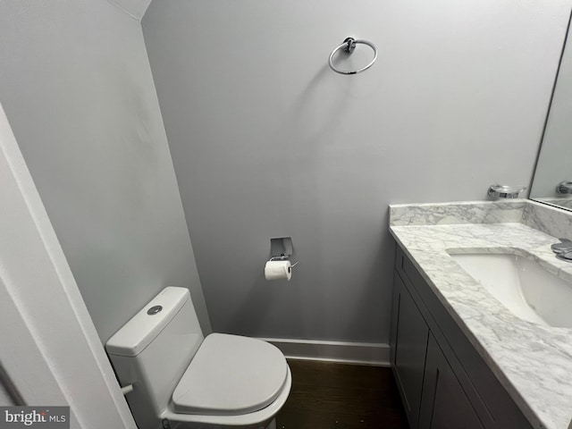 bathroom featuring vanity, toilet, and wood-type flooring