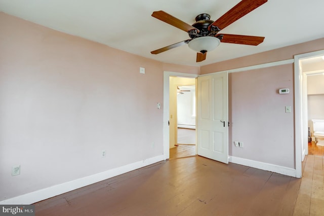 unfurnished bedroom with ensuite bathroom, ceiling fan, a baseboard heating unit, and dark hardwood / wood-style floors