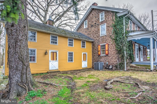 back of house featuring cooling unit and covered porch