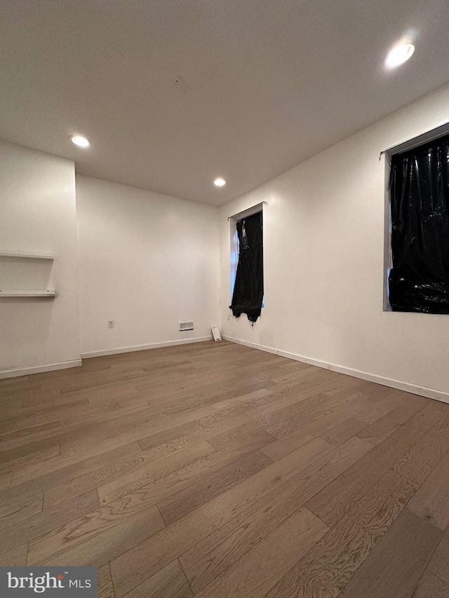 empty room with hardwood / wood-style flooring