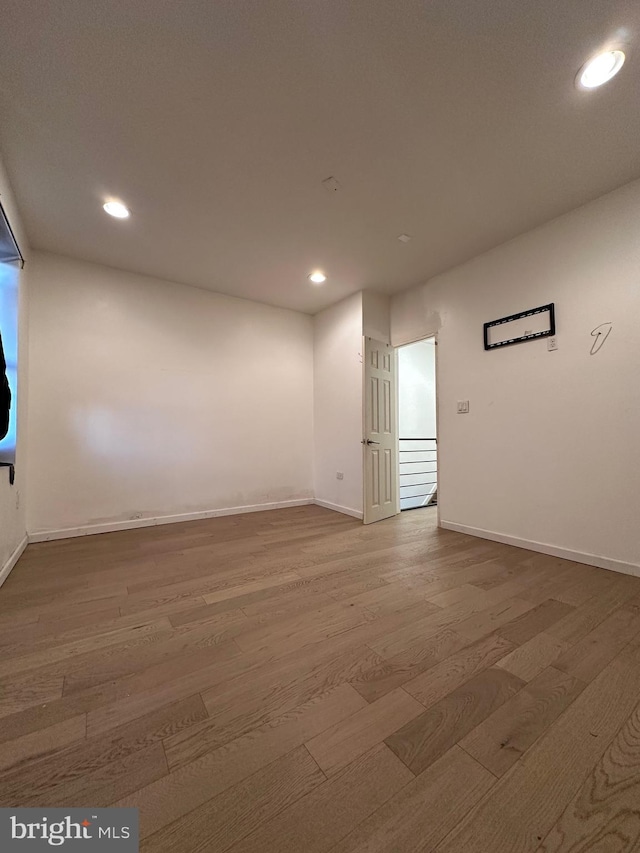 unfurnished room featuring hardwood / wood-style flooring