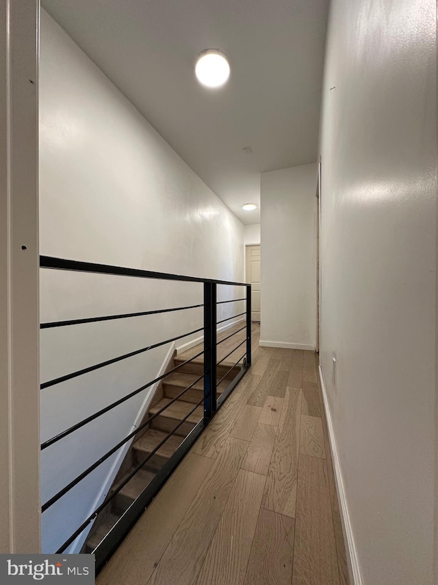 corridor with light hardwood / wood-style flooring