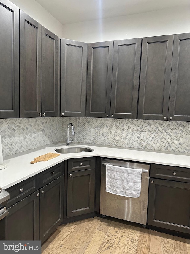 kitchen featuring dishwasher, sink, light hardwood / wood-style flooring, decorative backsplash, and dark brown cabinets