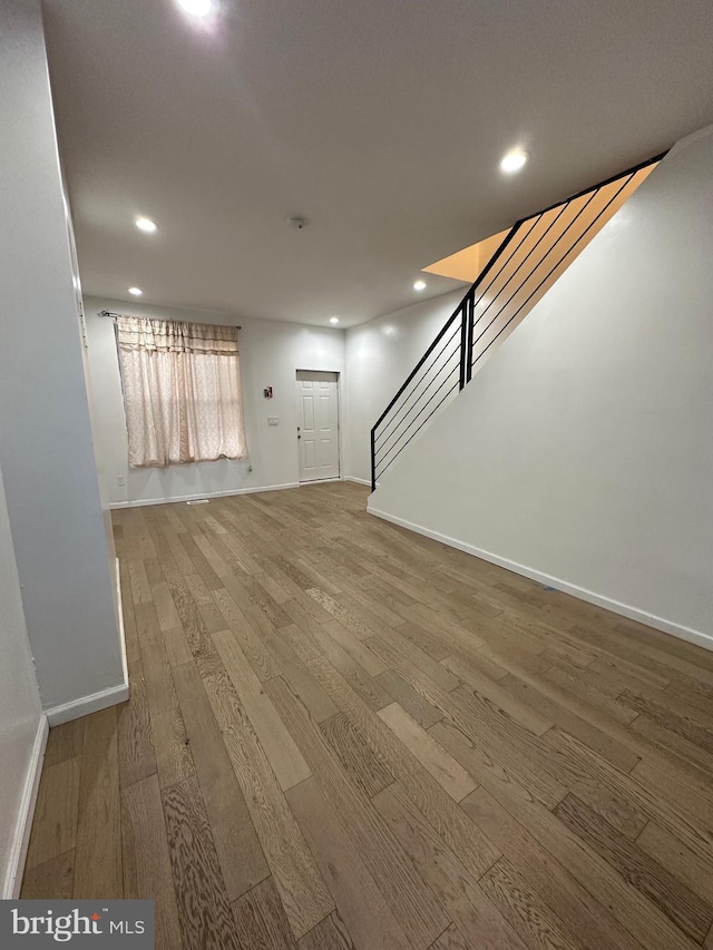 unfurnished living room with hardwood / wood-style flooring