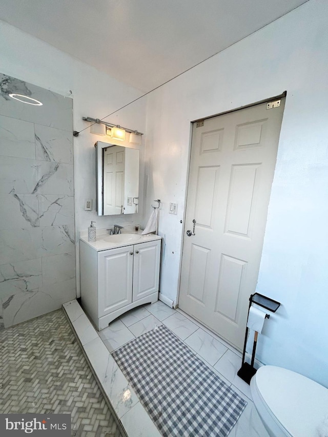 bathroom with vanity, toilet, and a shower