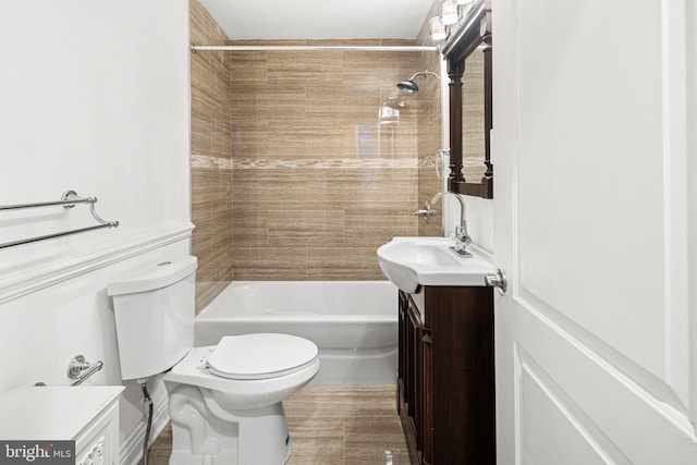 full bathroom featuring vanity, toilet, and tiled shower / bath combo