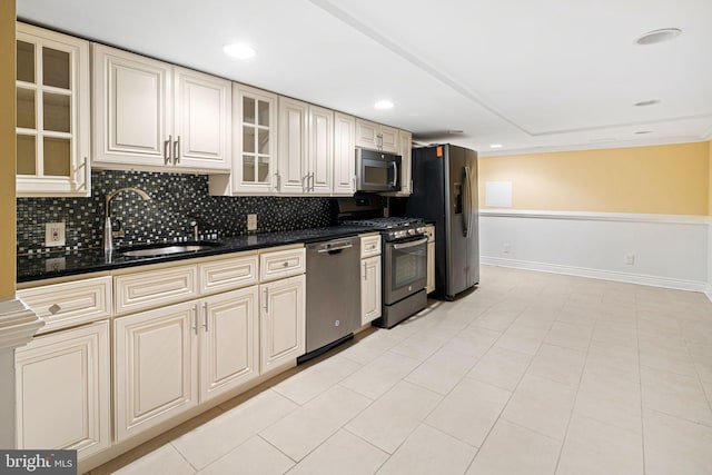 kitchen featuring sink, light tile patterned floors, cream cabinetry, and appliances with stainless steel finishes