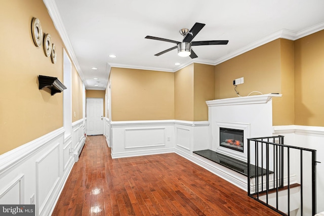 unfurnished living room featuring hardwood / wood-style flooring, ceiling fan, and ornamental molding