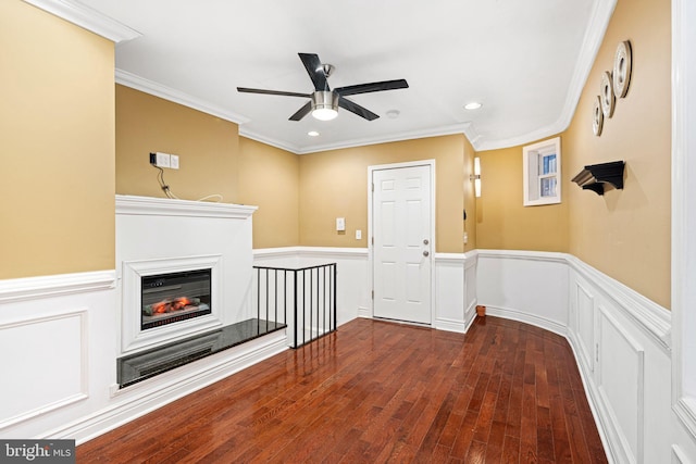 unfurnished living room with ceiling fan, dark wood-type flooring, and ornamental molding