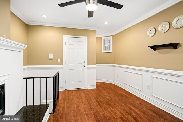 hall with hardwood / wood-style flooring and ornamental molding