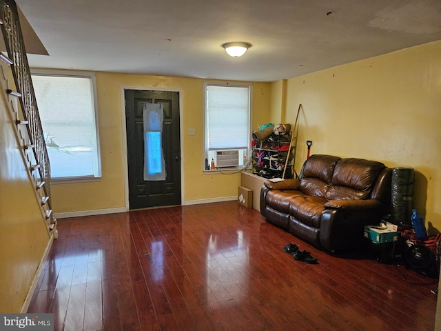 living room featuring a wealth of natural light, dark hardwood / wood-style flooring, and cooling unit