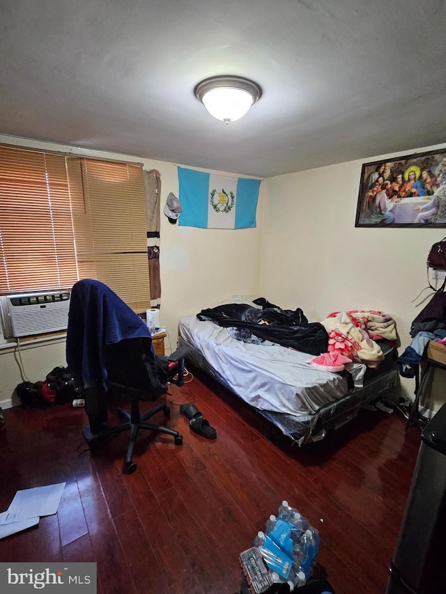 bedroom featuring hardwood / wood-style floors and cooling unit