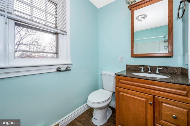 bathroom with hardwood / wood-style floors, vanity, and toilet