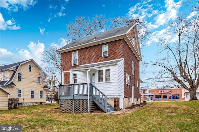 rear view of property featuring a lawn