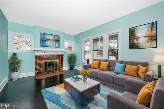 living room with dark hardwood / wood-style flooring and a fireplace