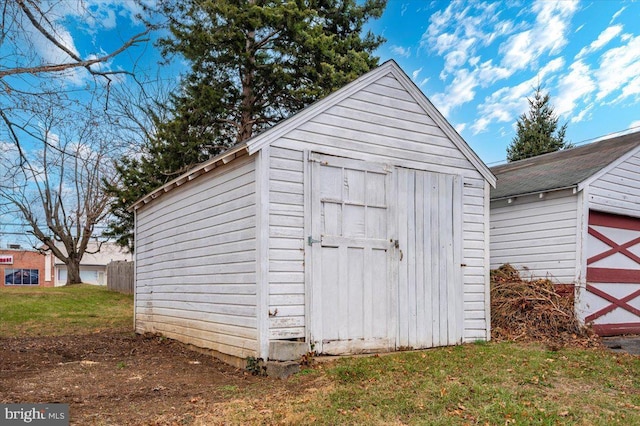 view of outbuilding featuring a yard