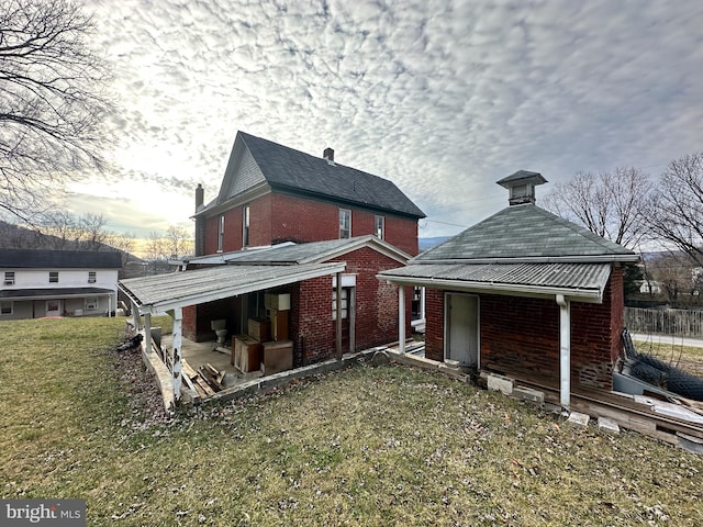 rear view of house with a lawn