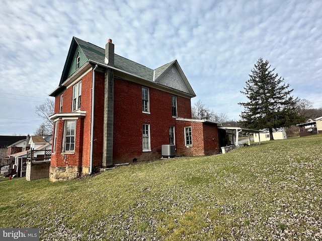 view of property exterior featuring a yard and central AC