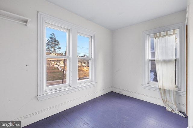 unfurnished room with dark hardwood / wood-style flooring