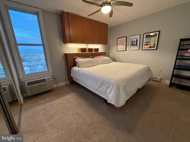 carpeted bedroom featuring an AC wall unit and ceiling fan