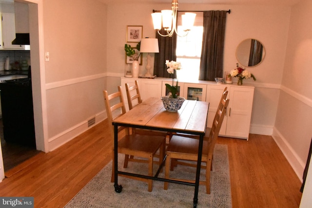 dining room featuring a chandelier and light wood-type flooring