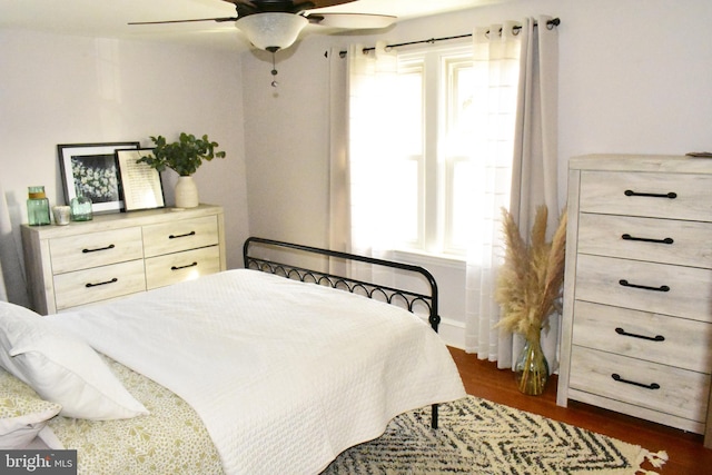 bedroom featuring ceiling fan and dark wood-type flooring