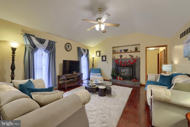 living room with built in shelves, dark hardwood / wood-style flooring, ceiling fan, and lofted ceiling