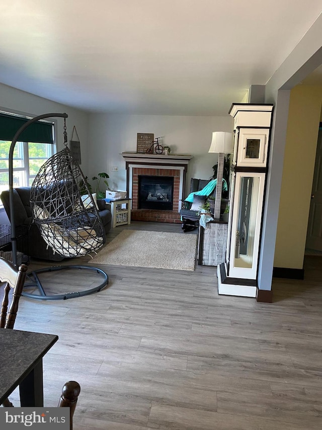 living room with a fireplace and wood-type flooring