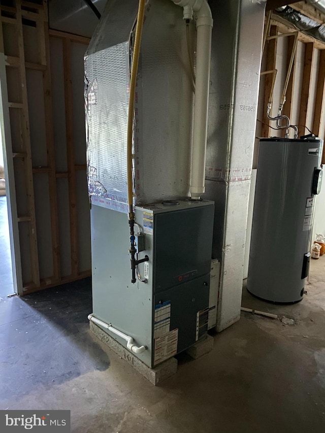 utility room with electric water heater and heating unit