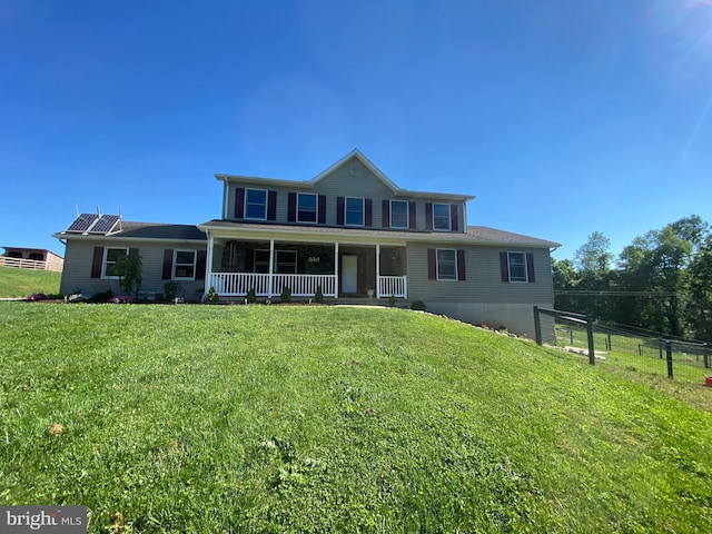 view of front of house featuring covered porch and a front lawn