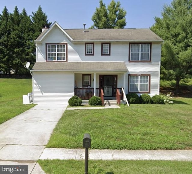 view of front of house with a porch and a front yard