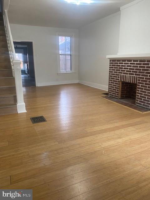 unfurnished living room featuring wood-type flooring