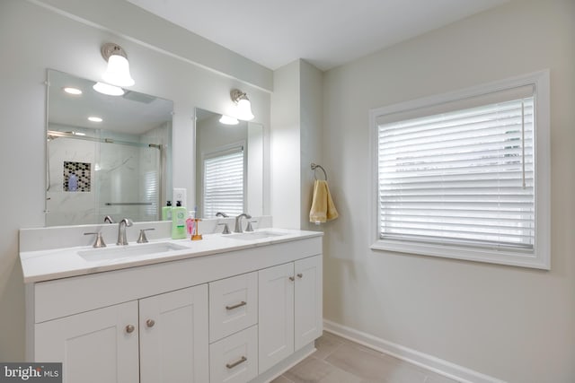 bathroom featuring vanity, tile patterned floors, and walk in shower