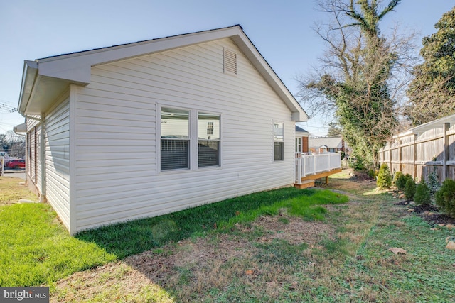 view of side of property with a yard