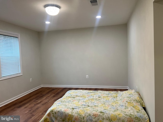 bedroom featuring dark hardwood / wood-style flooring