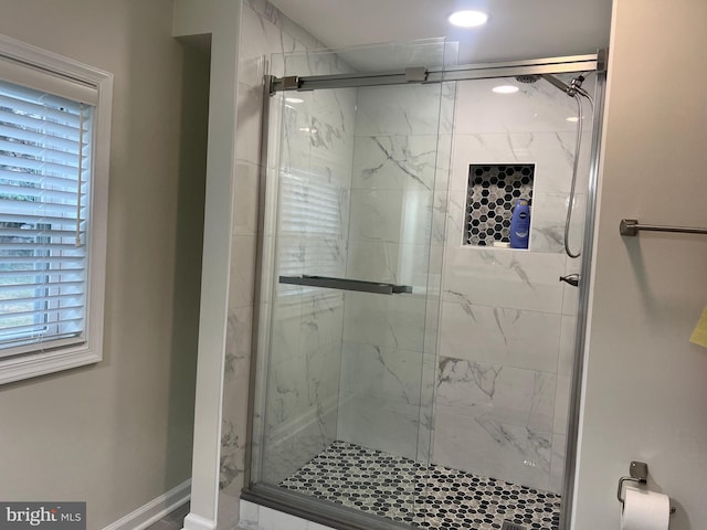 bathroom featuring a healthy amount of sunlight and an enclosed shower