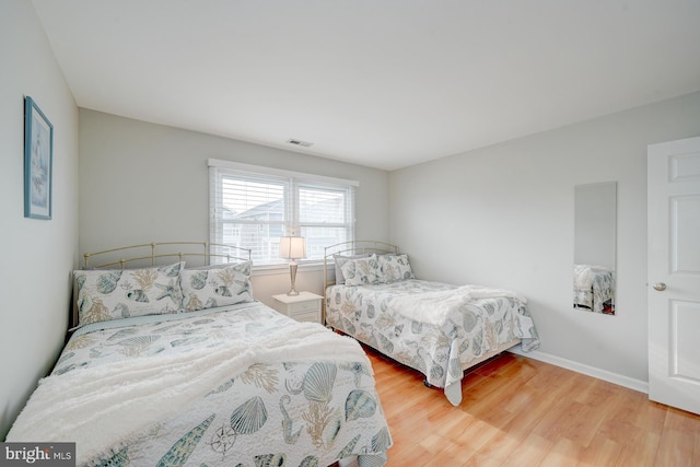 bedroom with wood-type flooring