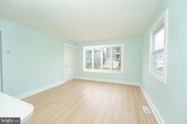 empty room with light hardwood / wood-style flooring