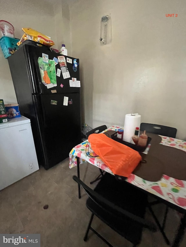 kitchen featuring black refrigerator and refrigerator