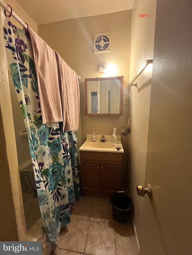 bathroom with tile patterned floors, vanity, and a shower with shower curtain